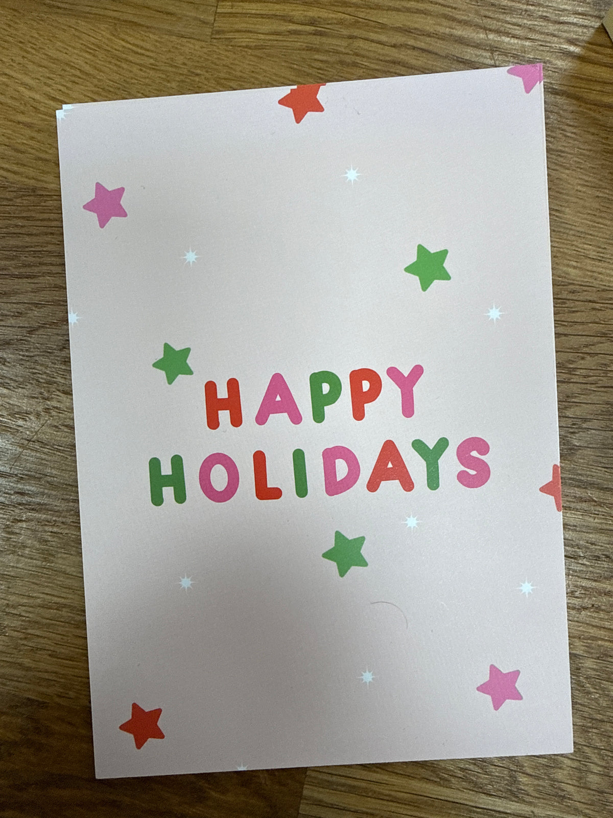 Postkarte „Happy Holidays“ mit bunten Sternen